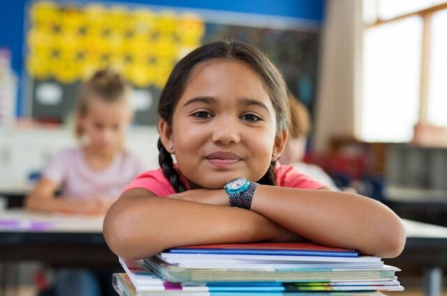 Little girl at desk in school