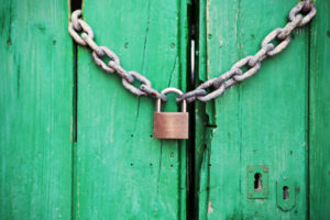 Padlock with Chain Securing Green door